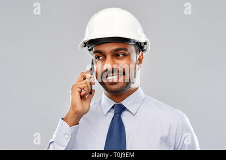 indian architect in helmet calling on smartphone Stock Photo