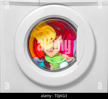 Washing machine with laundry loaded for washing. Stock Photo