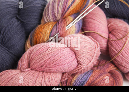 Pink, gray, multicolored yarn of wool in bundles for hand knitting, hand-painted in beautiful colors Stock Photo