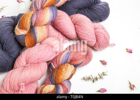 Pink, gray, multicolored yarn of wool in bundles for hand knitting, hand-painted in beautiful colors Stock Photo