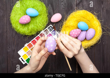 Women painting Easter eggs on table Stock Photo