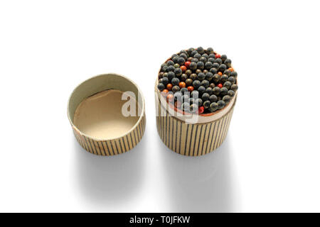 Open striped matches box with many matches, isolated on white background, close-up Stock Photo
