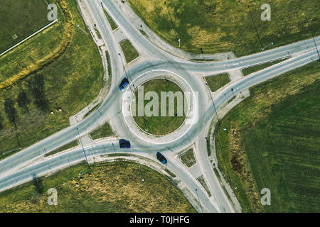 Aerial view of traffic circle roundabout road junction, top view with cars Stock Photo