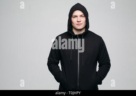 Serious athletic man in black hoodie. Stock Photo