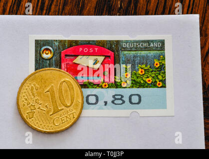 German stamp 80 cents and 10 cent coins, symbolic photo Portoerhöhung, Deutsche Briefmarke 80 Cent und 10 Centmünze, Symbolfoto Portoerhöhung Stock Photo