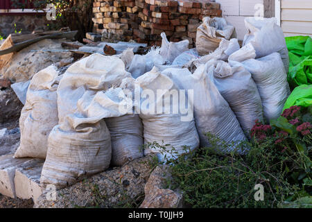 White construction garbage bags. Construction garbage bags piled on top of  one another. A large pile of construction garbage bags. abstract background  Stock Photo - Alamy