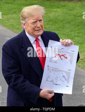Washington, District of Columbia, USA. 20th Mar, 2019. United States President Donald J. Trump shows a map showing the territory of the ''Iraq/Syria ISIS Physical Caliphate 2017'' (top) ''Iraq/Syria ISIS Physical Caliphate 2019'' (bottom) as he speaks to the media as he departs the South Lawn of the White House in Washington, DC for a day trip to Lima, Ohio and Canton, Ohio on Wednesday, March 20, 2019 Credit: Ron Sachs/CNP/ZUMA Wire/Alamy Live News Stock Photo