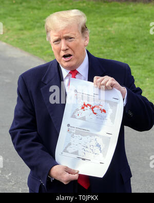 Washington, District of Columbia, USA. 20th Mar, 2019. United States President DONALD J. TRUMP shows a map showing the territory of the ''Iraq/Syria ISIS Physical Caliphate 2017'' (top) ''Iraq/Syria ISIS Physical Caliphate 2019'' (bottom) as he speaks to the media as he departs the South Lawn of the White House in Washington, DC for a day trip to Lima, Ohio and Canton, Ohio. Credit: Ron Sachs/CNP/ZUMA Wire/Alamy Live News Stock Photo
