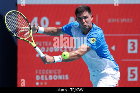 Miami Gardens, Florida, USA. 20th Mar, 2019. Federico Delbonis, of Argentina, returns a shot to Peter Gojowczyk, of Germany, at the 2019 Miami Open Presented by Itau professional tennis tournament, played at Hardrock Stadium in Miami Gardens, Florida, USA. Mario Houben/CSM/Alamy Live News Stock Photo