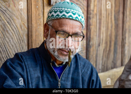 March 21, 2019 - Srinagar, Jammu and Kashmir, India - An old Kashmiri patient seen with leeches on his lips during leech treatment.A traditional health worker uses leeches to suck impure blood as part of a treatment at Hazratbal on the banks of the Dal Lake on the outskirts of Srinagar Summer capital of Indian administered Kashmir. Every year traditional health workers in Kashmir use leeches to treat people for itchy, painful lumps that develop on the skin called chilblains acquired during winter. Thousands of patients suffering from various skin problems receives leech treatment at Hazratbal Stock Photo