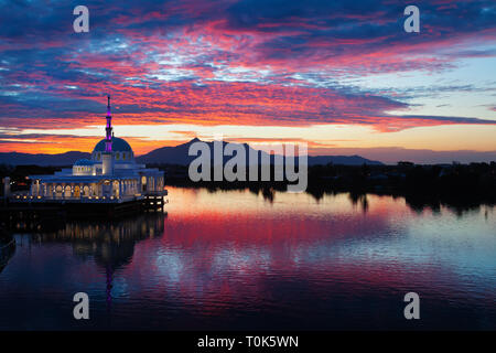 Scenic view of floating mosque on Sarawak river with colorful sunset clouds background. Waterfront landmark in Kota Kuching. Traditional culture Stock Photo