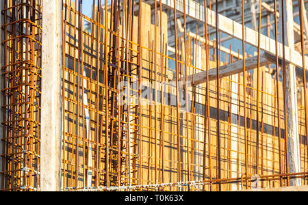 Reinforced concrete, under construction. Formworks and steel bars reinforcement in a construction site, closeup view. Stock Photo