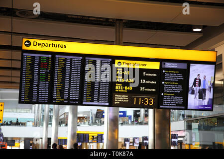 England Heathrow Airport Terminal Two Departures Board Stock Photo