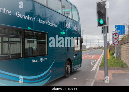 Portsmouth park and ride buse passing traffic lights and entering the slip road for the M275 Motorway Stock Photo