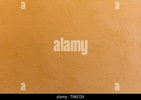 Orange color painted wall, building facade. Painted wall texture background Stock Photo