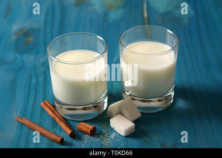 fresh milk in glasses with sugar cubes - closeup Stock Photo