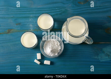 fresh milk in glasses with sugar cubes - closeup Stock Photo