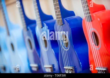 Red and blue ukulele guitar or guitars Stock Photo