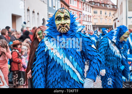 Carnival figure with blue costume and green mask. Street Carnival in Southern Germany - Black Forest. Stock Photo