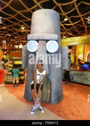 Young girl posing for a photograph at Universal Studios, Orlando, USA Stock Photo