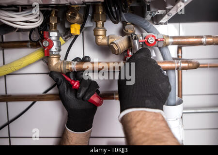 plumber fixing central heating system Stock Photo