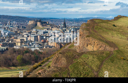 View of city of Edinburgh over Salisbury Crags from Arthur's Seat , Edinburgh, Scotland, UK. Stock Photo