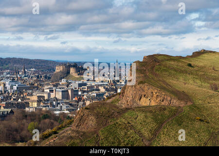 View of city of Edinburgh over Salisbury Crags from Arthur's Seat , Edinburgh, Scotland, UK. Stock Photo