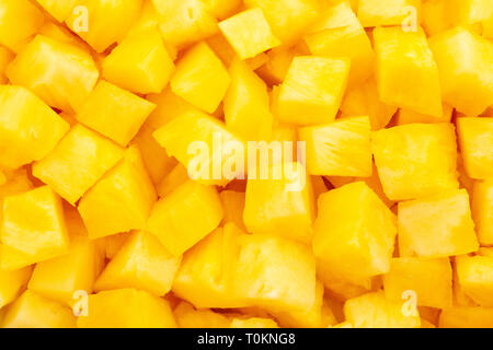 sliced pineapple cubes texture background Stock Photo