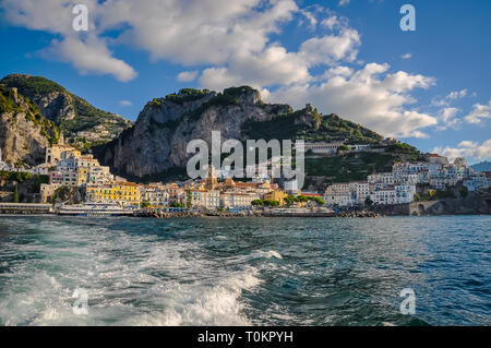 AMALFI, ITALY - SEPTEMBER 11 2013: Panorama of the town from the sea, with a ferry departing from the pier Stock Photo