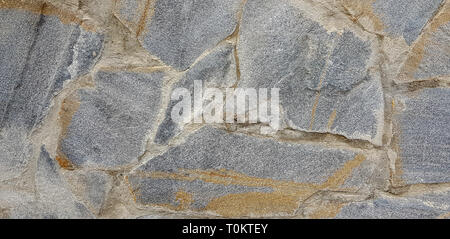 Stone wall rustic texture background. Textured stone wall closeup. Stock Photo