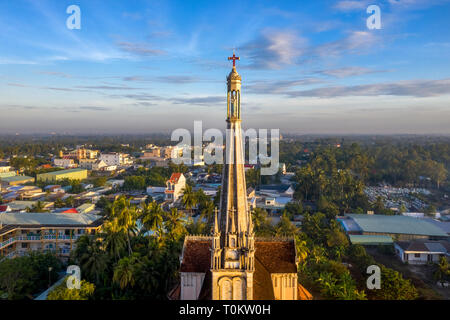 Aerial view of Cai Be church in the Mekong Delta, In front is Cai Be floating market. Bell tower and the statue of Blessed Mother. Tien Giang, Vietnam Stock Photo