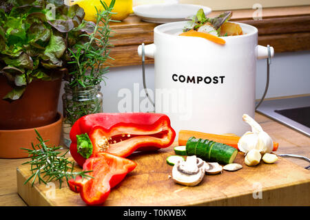 Food waste recycling kitchen, food waste from food preparation collected for recycling in kitchen compost collecting container with chopped vegetables Stock Photo