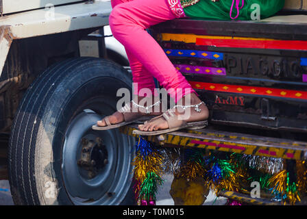 AGRA, INDIA - NOVEMBER 15, 2012: Indian woman's legs are decorated with bracelets, traditional jewelry Stock Photo