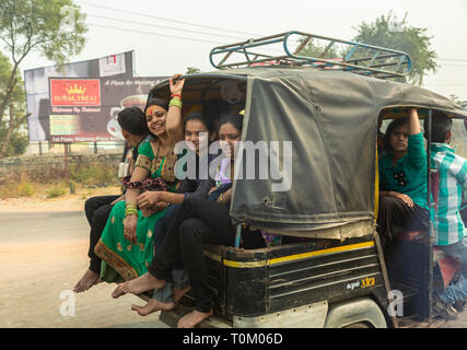 AGRA, INDIA - NOVEMBER 16, 2012: Traffic on the streets of India. Large Indian families travel in one small car. Indian people and their colorful cult Stock Photo