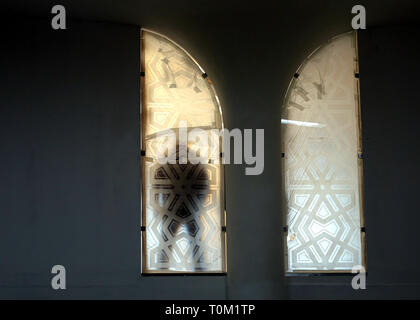 The silhouette of a man standing in the window of the building is photographed close-up Stock Photo