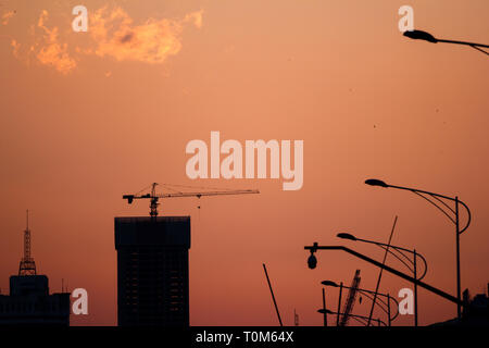 Building under construction with red sky background Stock Photo