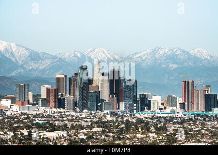 Downtown of Los Angeles against snow capped mountains Stock Photo