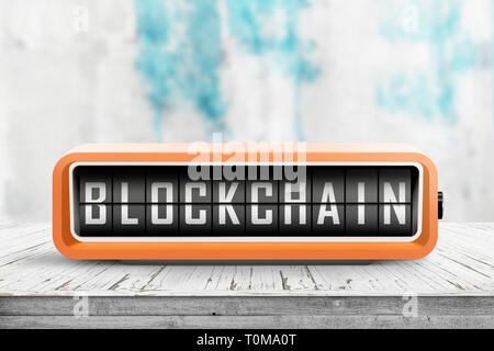 Blockchain alarm message on a retro alarm clock on a table in a bright room Stock Photo