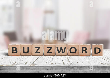 Buzzword made of wooden blocks on a table in a bright room in daylight Stock Photo