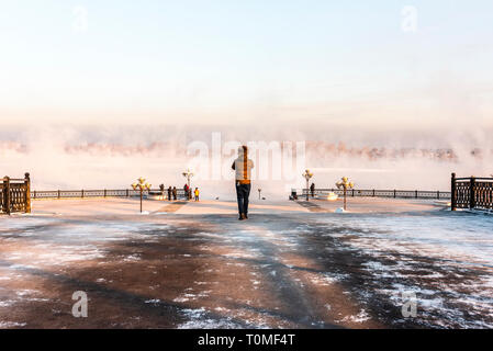 Man standing on the banks of the Irkut, Irkutsk, Siberia, Russia Stock Photo