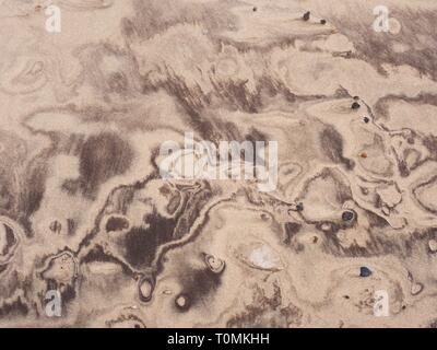 Desert sand pattern with  beautiful shapes from crushed shells and another sediments, natural background Stock Photo