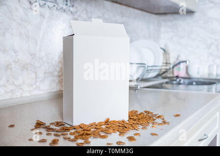 Generic box of cereals on the kitchen table. White package of ready breakfast in home background Stock Photo