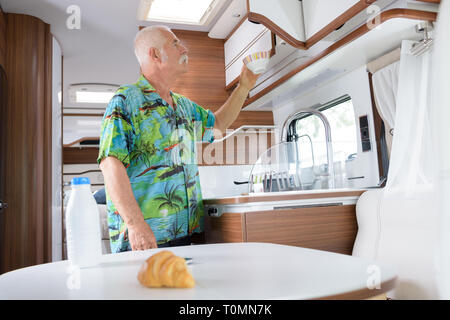 senior man inside campervan Stock Photo