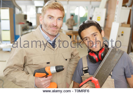 engineer teaching apprentices with machines Stock Photo