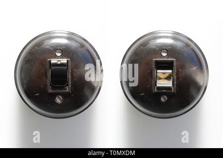 Antique two switches on-off bakelite, isolated on white background, close-up Stock Photo