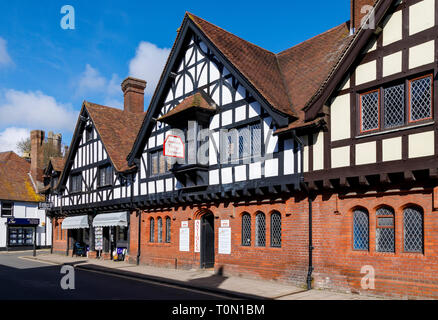 High Street, Arundel, West Sussex. Businesses within a mid C19 half timbered and red brick building with leaded windows and tiled roof. Stock Photo