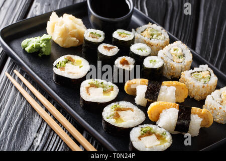 Delicious Japanese sushi rolls big set close-up on a plate on the table. horizontal Stock Photo