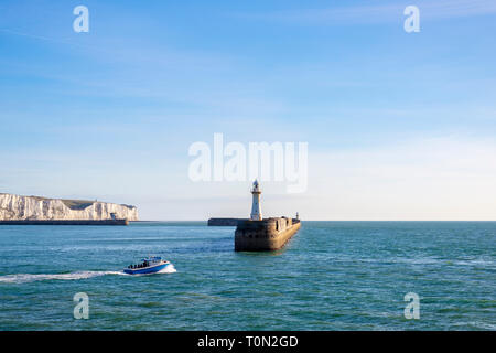 A fishing boat leaving the port of Dover; with the iconic White Cliffs in the background. Stock Photo