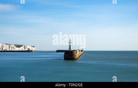 A view of the southern breakwater in the Port of Dover; with the famous White Cliffs in the background. Stock Photo