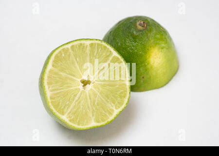 a cutted lime on a plain white table Stock Photo - Alamy